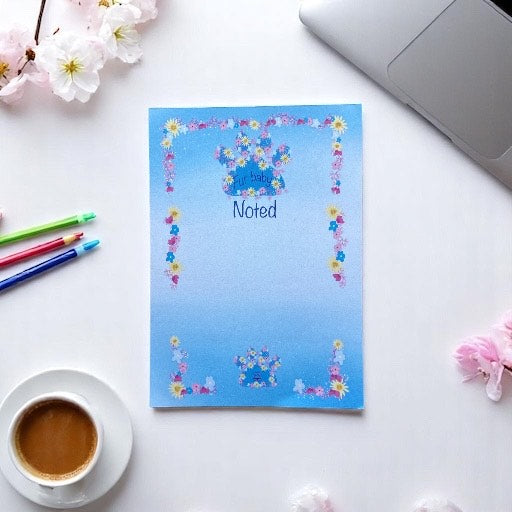 "Blue A6 hardback notepad with elegant paw print design on cover, perfect for pet lovers and professionals"