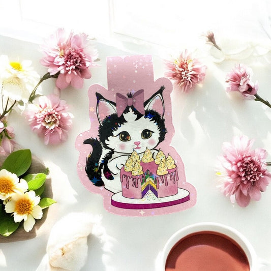 "Close-up of cute kitten magnetic bookmark with cake and holographic elements, showing quality printing and magnetic closure"