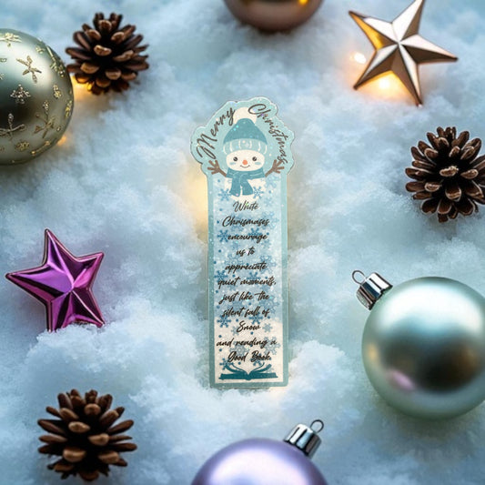 Christmas-themed bookmark with decorative ornaments on a snowy background
