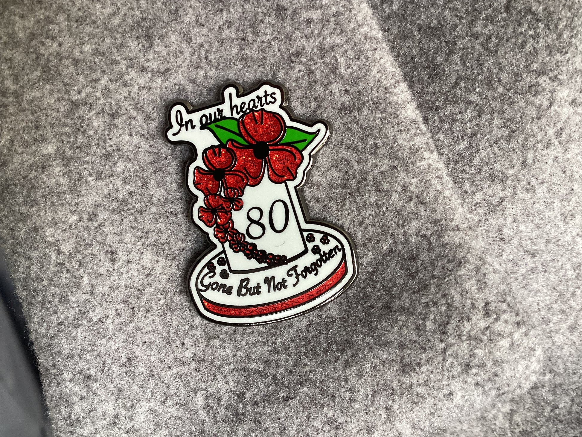 80th Anniversary VE Day Poppy Enamel Pin worn on clothing - Remembrance badge showing how it can be displayed as a respectful tribute to fallen soldiers