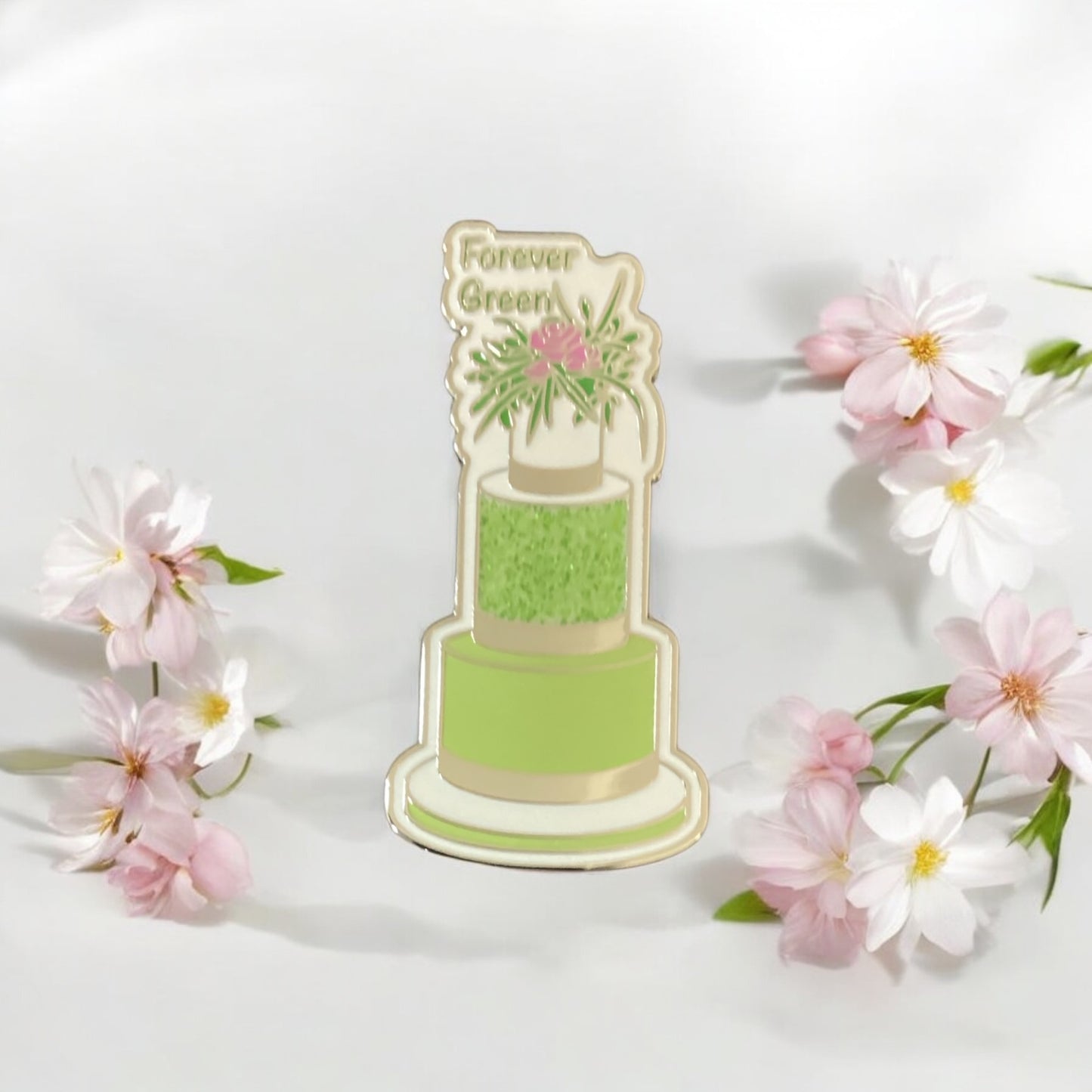 Close-up of Green Three-Tier Cake Enamel Pin showing intricate floral pattern and silver accents - High-quality hard enamel finish with sparkle details