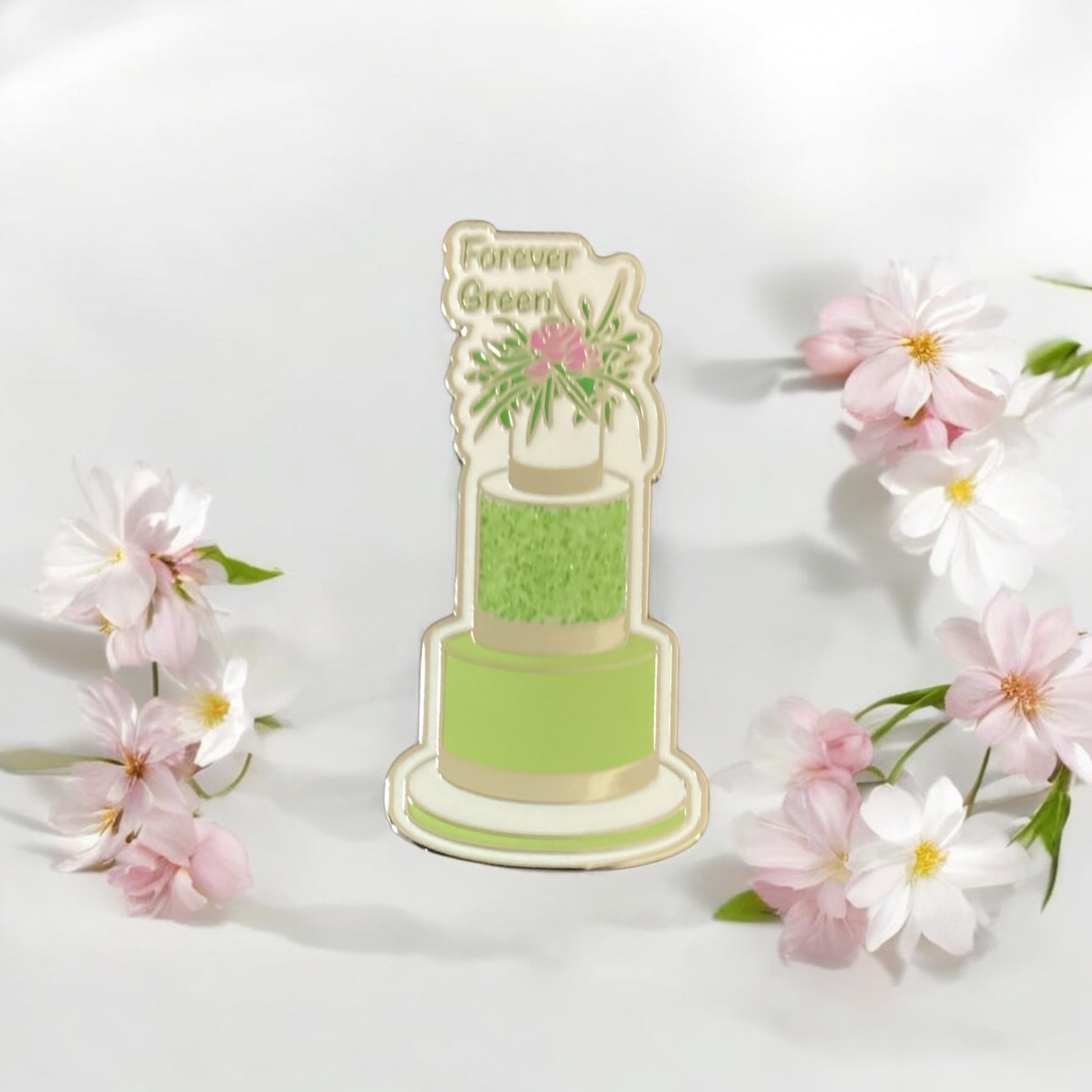 Close-up of Green Three-Tier Cake Enamel Pin showing intricate floral pattern and silver accents - High-quality hard enamel finish with sparkle details