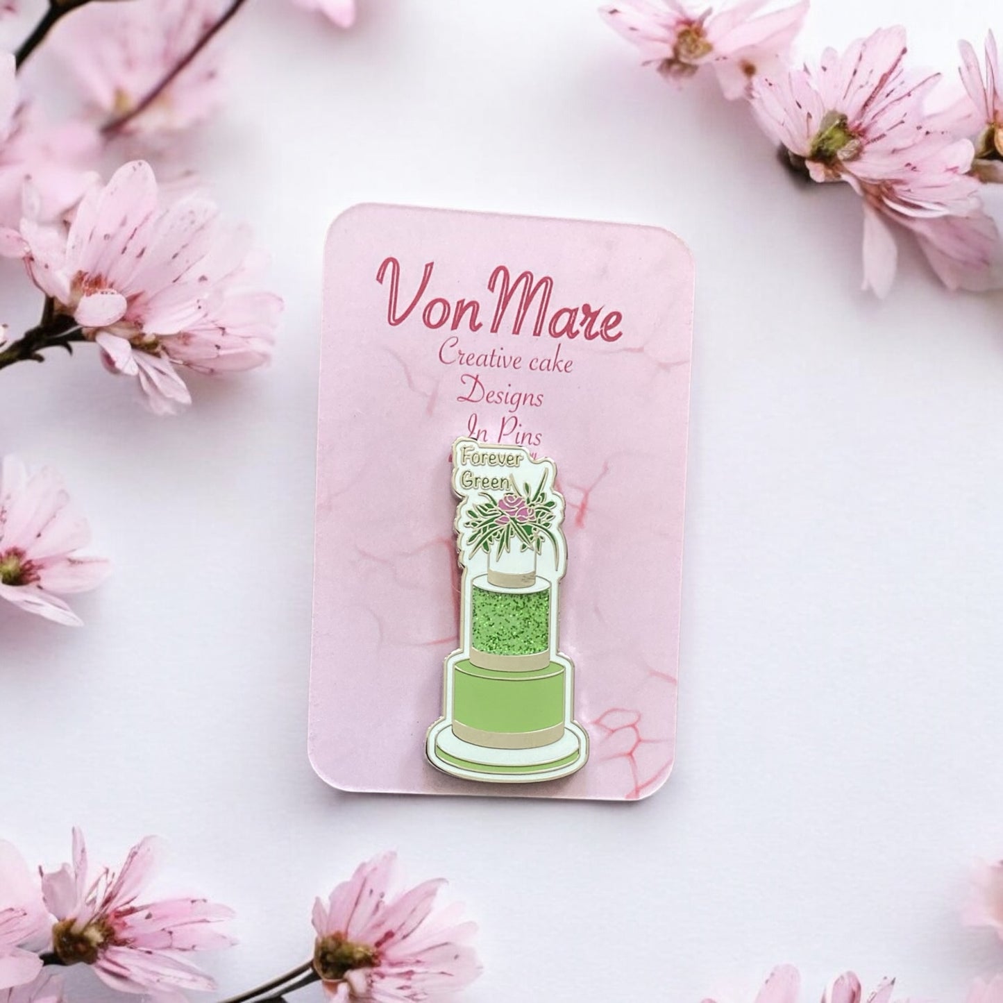 Green Three-Tier Cake Enamel Pin on display card - Elegant floral cake design collectible with secure dual pin backing - Perfect gift for bakers and pin collectors