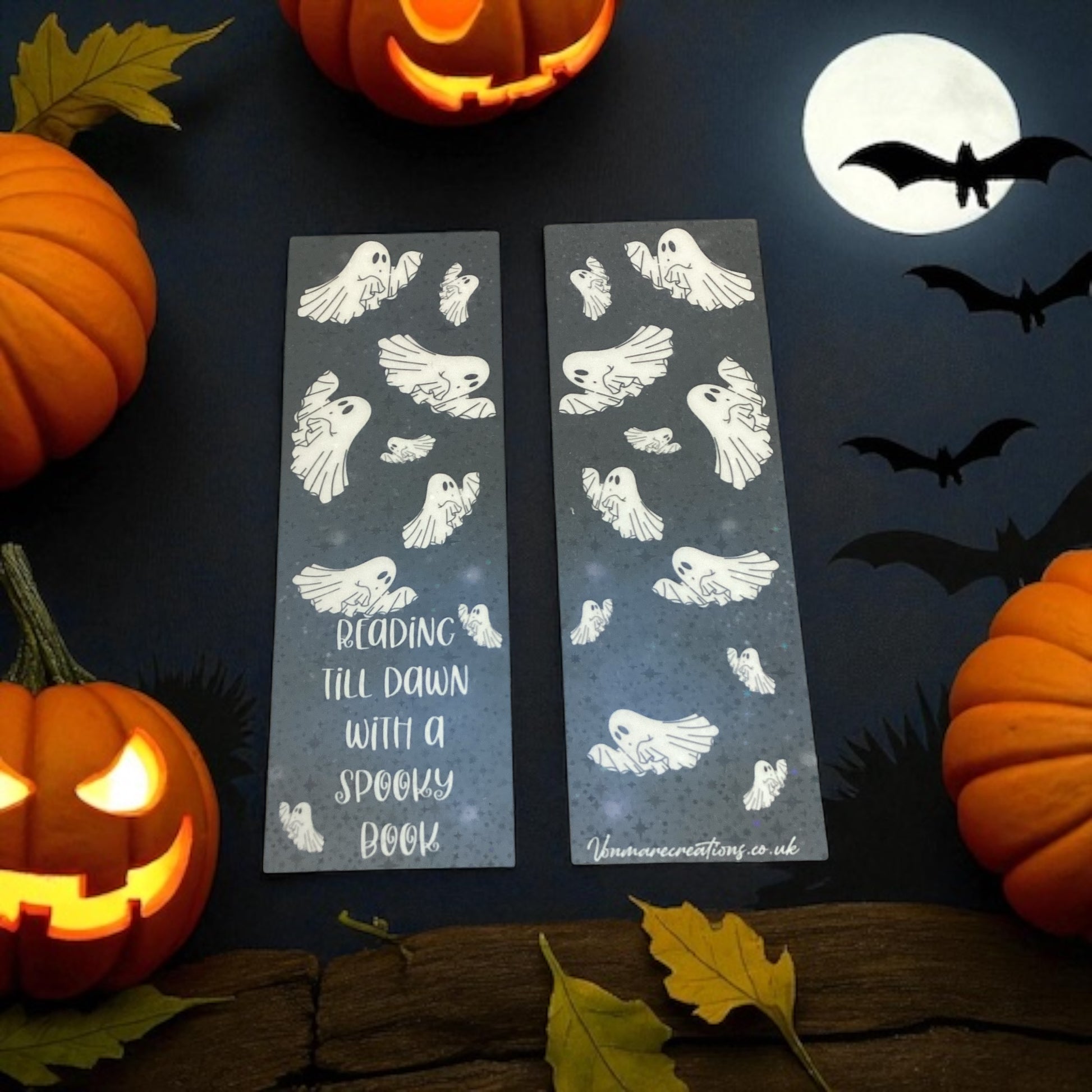 Halloween-themed bookmarks with ghost designs on a dark background with pumpkins and bats.