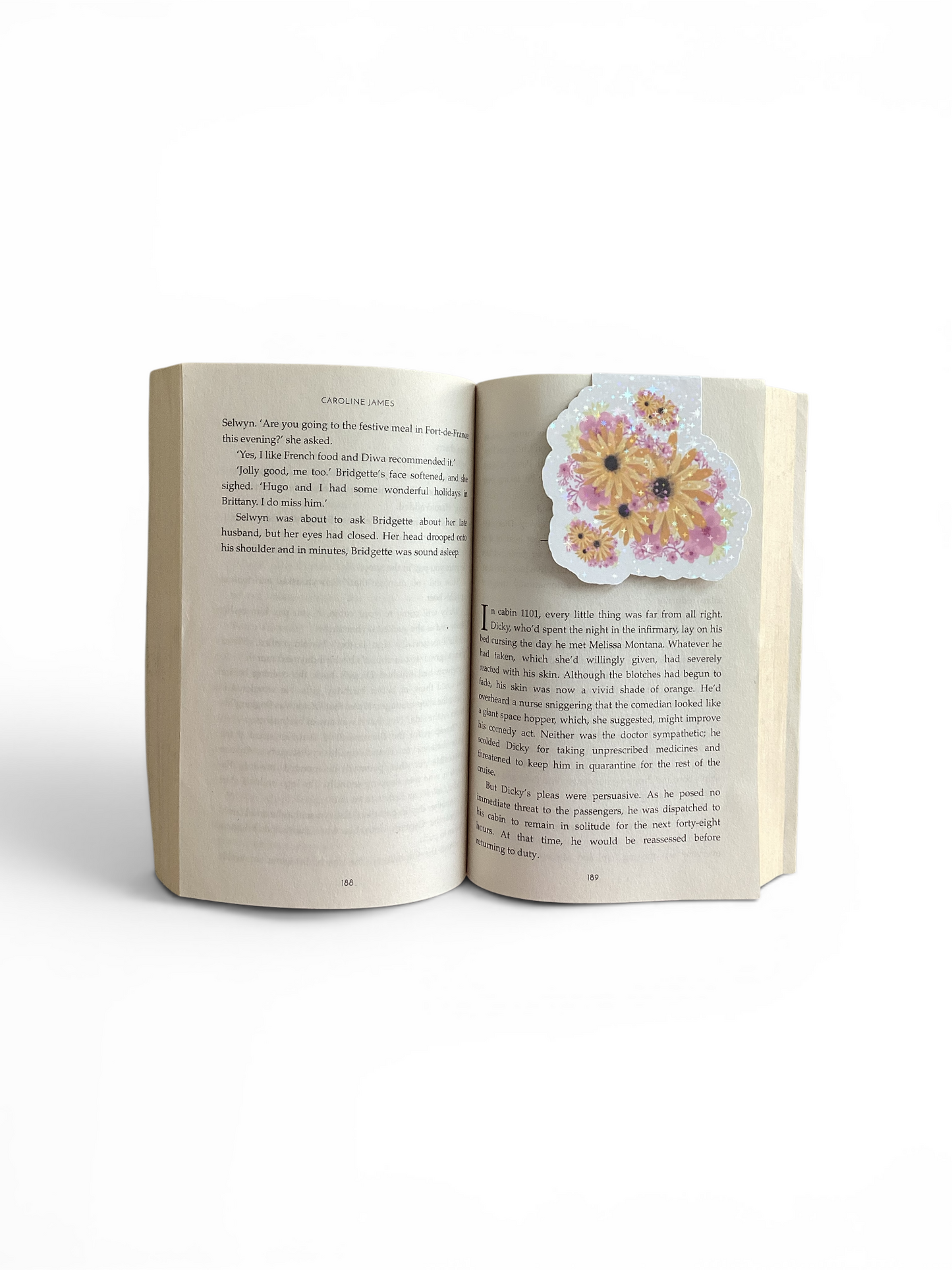 Studio photo of an open book with a magnetic bookmark floral design